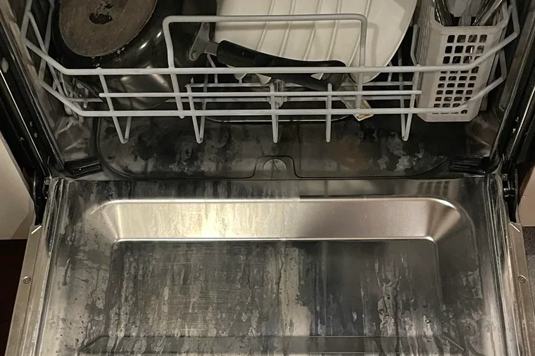 Hard water scale buildup inside a dishwasher