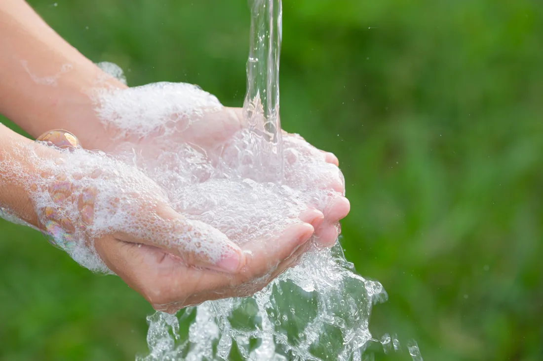 Hands being washed with clean running water